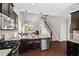 Open-concept kitchen with stainless steel appliances, granite countertops, and a seamless layout at 114 Mt Evans Dr, Durham, NC 27705
