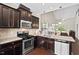 Well-appointed kitchen with modern appliances, granite countertops and sleek dark cabinets at 114 Mt Evans Dr, Durham, NC 27705
