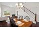 Open-concept living area with hardwood floors, high ceilings, and ample natural light at 114 Mt Evans Dr, Durham, NC 27705