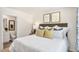 Bedroom with art, linen bedding, and an ensuite bathroom view, offering a peaceful retreat at 123 Holmes Corner Dr, Smithfield, NC 27577