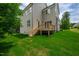 Backyard features a wood deck with staircase and lush lawn at 12912 Grey Willow Dr, Raleigh, NC 27613