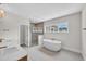 Bright bathroom with a soaking tub, glass shower, and vanity with double sinks at 12912 Grey Willow Dr, Raleigh, NC 27613
