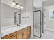 Modern bathroom with a glass shower, vanity with sink, and elegant lighting fixtures at 12912 Grey Willow Dr, Raleigh, NC 27613