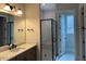 Modern bathroom features double vanity with sleek fixtures and a glass-enclosed shower with designer tile at 12912 Grey Willow Dr, Raleigh, NC 27613
