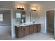 Bathroom featuring double vanity sinks, wood cabinets, and tile floors at 12912 Grey Willow Dr, Raleigh, NC 27613
