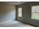 Bright bedroom with two windows offering natural light and comfortable carpet at 12912 Grey Willow Dr, Raleigh, NC 27613