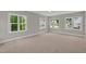 Bright and spacious bedroom featuring ample natural light from large windows at 12912 Grey Willow Dr, Raleigh, NC 27613