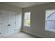 Neutral bedroom featuring carpet, a ceiling fan, natural light and a double door closet at 12912 Grey Willow Dr, Raleigh, NC 27613