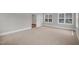 Neutral bedroom with carpet and windows, providing a serene and comfortable space at 12912 Grey Willow Dr, Raleigh, NC 27613
