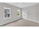 Neutral bedroom featuring large window and closet space, creating an inviting atmosphere at 12912 Grey Willow Dr, Raleigh, NC 27613