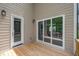 Wooden deck offers natural light and easy home access with white door and glass slider at 12912 Grey Willow Dr, Raleigh, NC 27613