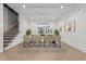 Dining room featuring modern chandelier, hardwood floors, and sunlit window views at 12912 Grey Willow Dr, Raleigh, NC 27613