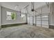 Spacious garage with concrete floors, window and dual white doors at 12912 Grey Willow Dr, Raleigh, NC 27613