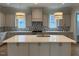 Modern kitchen with an island, pendant lights, and stainless steel appliances at 12912 Grey Willow Dr, Raleigh, NC 27613