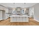 Spacious kitchen with a large island, modern appliances, pendant lighting, and stylish backsplash at 12912 Grey Willow Dr, Raleigh, NC 27613