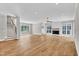 Spacious living room features hardwood floors, a fireplace, modern lighting, and staircase at 12912 Grey Willow Dr, Raleigh, NC 27613