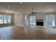Large open living room with fireplace, hardwood floors, and natural light at 12912 Grey Willow Dr, Raleigh, NC 27613