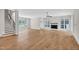 Bright living room featuring hardwood floors, a fireplace, modern lighting, and staircase at 12912 Grey Willow Dr, Raleigh, NC 27613