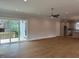 Bright open-concept living room with hardwood floors and sliding doors to deck at 12912 Grey Willow Dr, Raleigh, NC 27613
