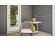 Cozy patio area featuring a chair and gardening accessories near a white-framed door at 135 Holmes Corner Dr, Smithfield, NC 27577