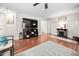 Spacious living room featuring a decorative fireplace, ample lighting, and access to other areas of the home at 166 Hammerstone Dr, Fuquay Varina, NC 27526