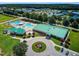 Aerial view of the Community clubhouse, pool area, and surrounding greenery in the neighborhood at 173 E Wilson St, Clayton, NC 27520