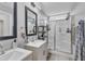 Modern bathroom featuring a double vanity, a glass-enclosed shower, and sleek fixtures at 173 E Wilson St, Clayton, NC 27520