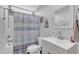 Well-lit bathroom featuring a tub and shower combination and modern vanity at 173 E Wilson St, Clayton, NC 27520