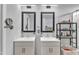 Bathroom featuring double sinks, modern fixtures, stylish mirrors, and ample counter space at 173 E Wilson St, Clayton, NC 27520