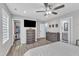 Stylish bedroom featuring an ensuite bathroom, walk-in closet, hardwood floors, and a ceiling fan at 173 E Wilson St, Clayton, NC 27520