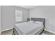 Neutral bedroom with a comfortable bed and a simple window at 173 E Wilson St, Clayton, NC 27520