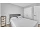 Simple, neutral bedroom with a closet and a comfortable bed at 173 E Wilson St, Clayton, NC 27520