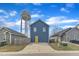 Charming blue home with a bright yellow door and a water tower in the background at 173 E Wilson St, Clayton, NC 27520