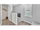 Bright hallway with wood-look floors, neutral paint, modern decor and a frosted window at 173 E Wilson St, Clayton, NC 27520