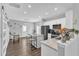 Bright kitchen features white cabinets, granite countertops, an island with seating, and stainless steel appliances at 173 E Wilson St, Clayton, NC 27520