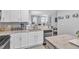 Kitchen with light grey backsplash, granite countertops, and stainless steel appliances at 173 E Wilson St, Clayton, NC 27520