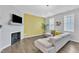 Stylish living room featuring a large sectional sofa, fireplace, and eye-catching accent wall at 173 E Wilson St, Clayton, NC 27520