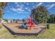 Community playground featuring slides and swings on a bright sunny day with blue sky at 173 E Wilson St, Clayton, NC 27520