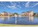 Pond with statues and fountains situated in front of townhomes with a blue sky backdrop at 173 E Wilson St, Clayton, NC 27520
