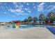 Community pool with splash pad and play equipment for on a sunny day at 173 E Wilson St, Clayton, NC 27520