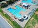 Aerial view of sparkling swimming pool with waterslide, sun loungers, and a covered seating area at 173 E Wilson St, Clayton, NC 27520