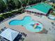 Aerial view of the community pool including ample lounge chairs, a slide, and a splash area at 173 E Wilson St, Clayton, NC 27520