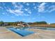 Outdoor pool featuring a waterslide and surrounded by ample deck space under a clear blue sky at 173 E Wilson St, Clayton, NC 27520