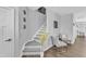 Open staircase with gray steps and patterned risers, leading to a living area with stylish decor at 173 E Wilson St, Clayton, NC 27520