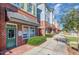 Commercial storefront of townhomes along a sidewalk with green space on a sunny day at 173 E Wilson St, Clayton, NC 27520