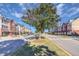 Charming street view of colorful townhomes with tree-lined sidewalks, adding to the neighborhood's appeal at 173 E Wilson St, Clayton, NC 27520