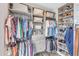 Custom walk-in closet with ample hanging space, shelving, drawers, and shoe racks at 173 E Wilson St, Clayton, NC 27520