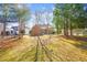 Spacious backyard featuring mature trees, lush lawn, and privacy, perfect for outdoor activities and entertaining at 2 Poplar Ave, Elon, NC 27244