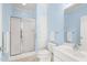 Bathroom featuring a walk-in shower, a storage cabinet, and a vanity at 2 Poplar Ave, Elon, NC 27244