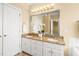 Bathroom featuring a double vanity, granite countertops, and stylish lighting fixtures at 2 Poplar Ave, Elon, NC 27244